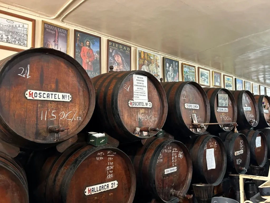 Barrels and wine glasses inside Casa de Guardia, Málaga's oldest traditional bodega
