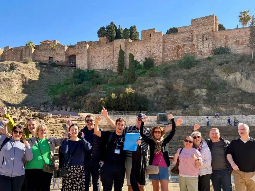 Tourguide with free walking tour group in malaga in roman theatre