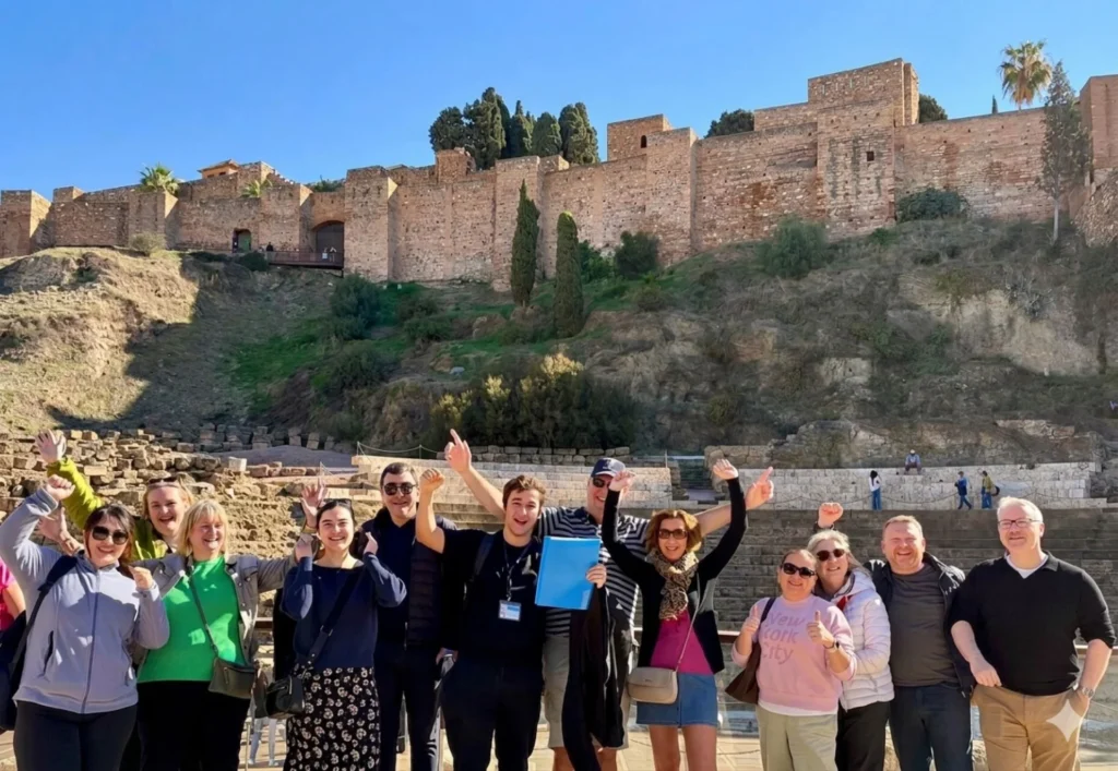 Tourguide with free walking tour group in malaga in roman theatre