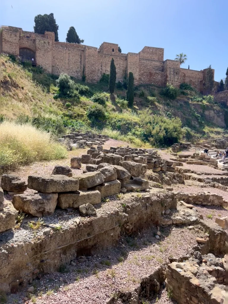 Your free tour guide shows you the ruins of the roman theatre and the alcazaba fortress on top
