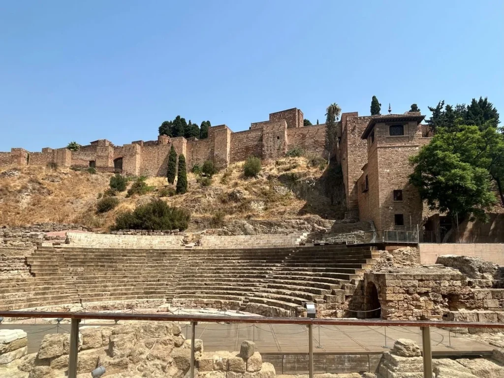 Ancient Roman theatre ruins in Málaga with the Alcazaba fortress in the background