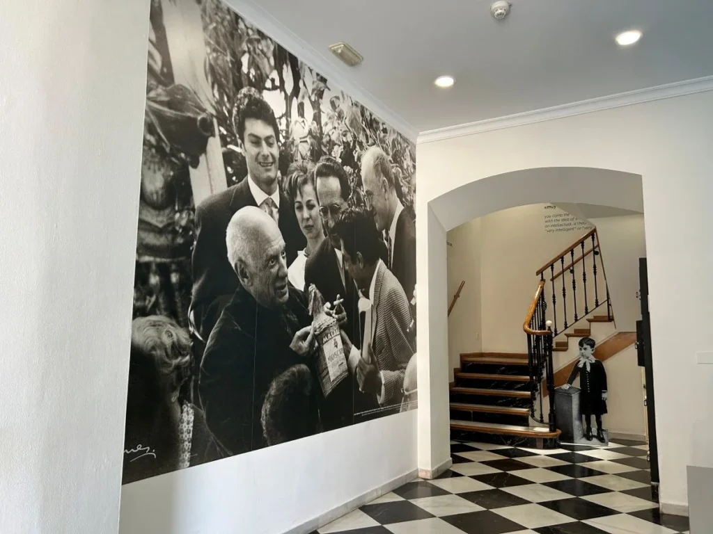 Interior of Picasso's birthplace museum in Málaga with historic black and white photography on the walls