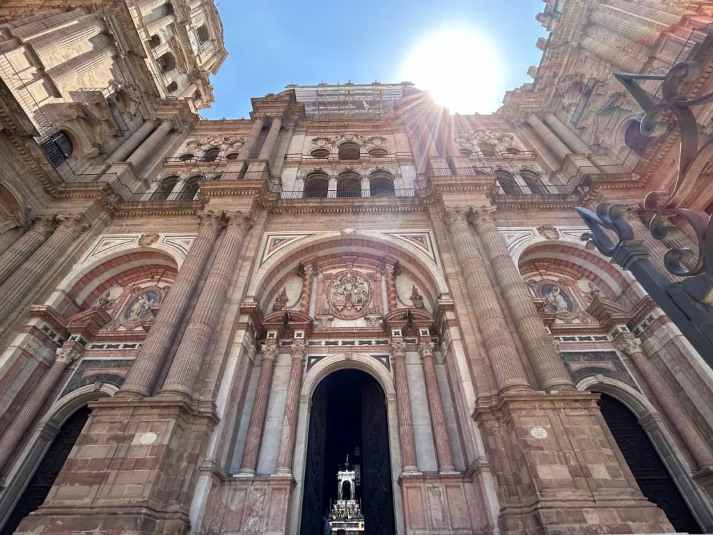 La Manquita Cathedral Málaga with its unfinished tower visible against a blue sky