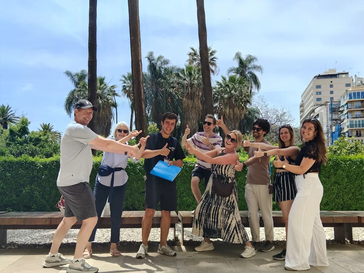 Free walking tour malaga group with the licensed local guide in front of museum de malaga with palm trees in the background