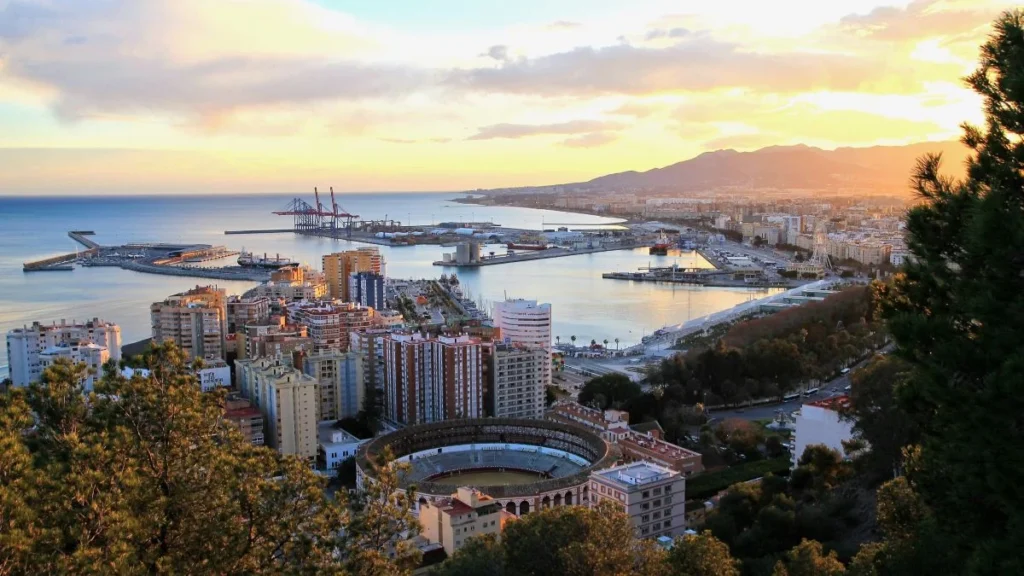 Golden sunset view from Gibralfaro Castle over Málaga city bullring port and Mediterranean sea