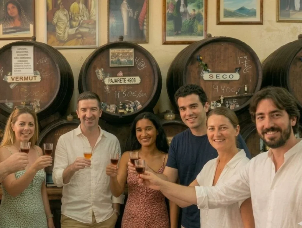 Tapas tour group in a typical andalusian bodega bar enjoying their tapas tour in Málaga with wine and food