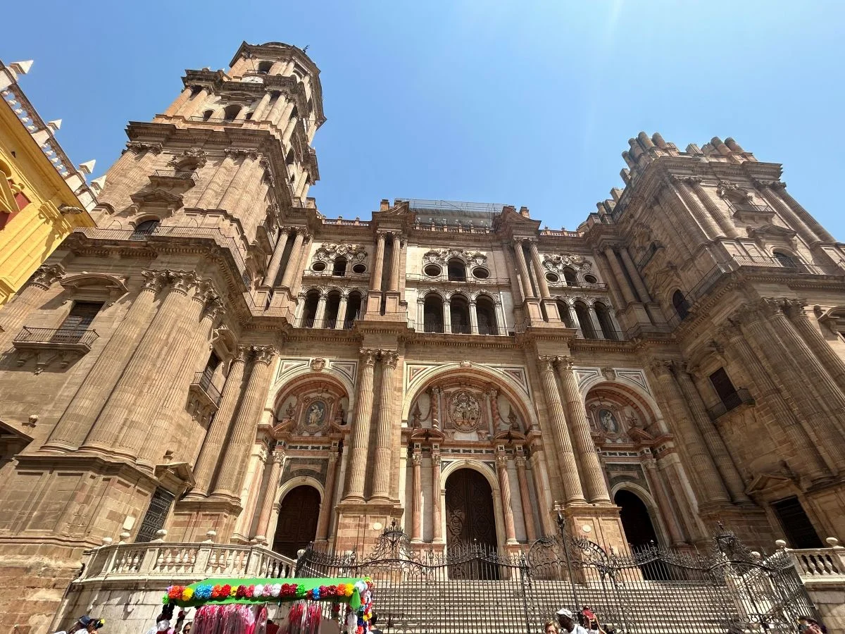 cathedral la manquita from the front in the historic centre of malaga on a sunny day with blue sky