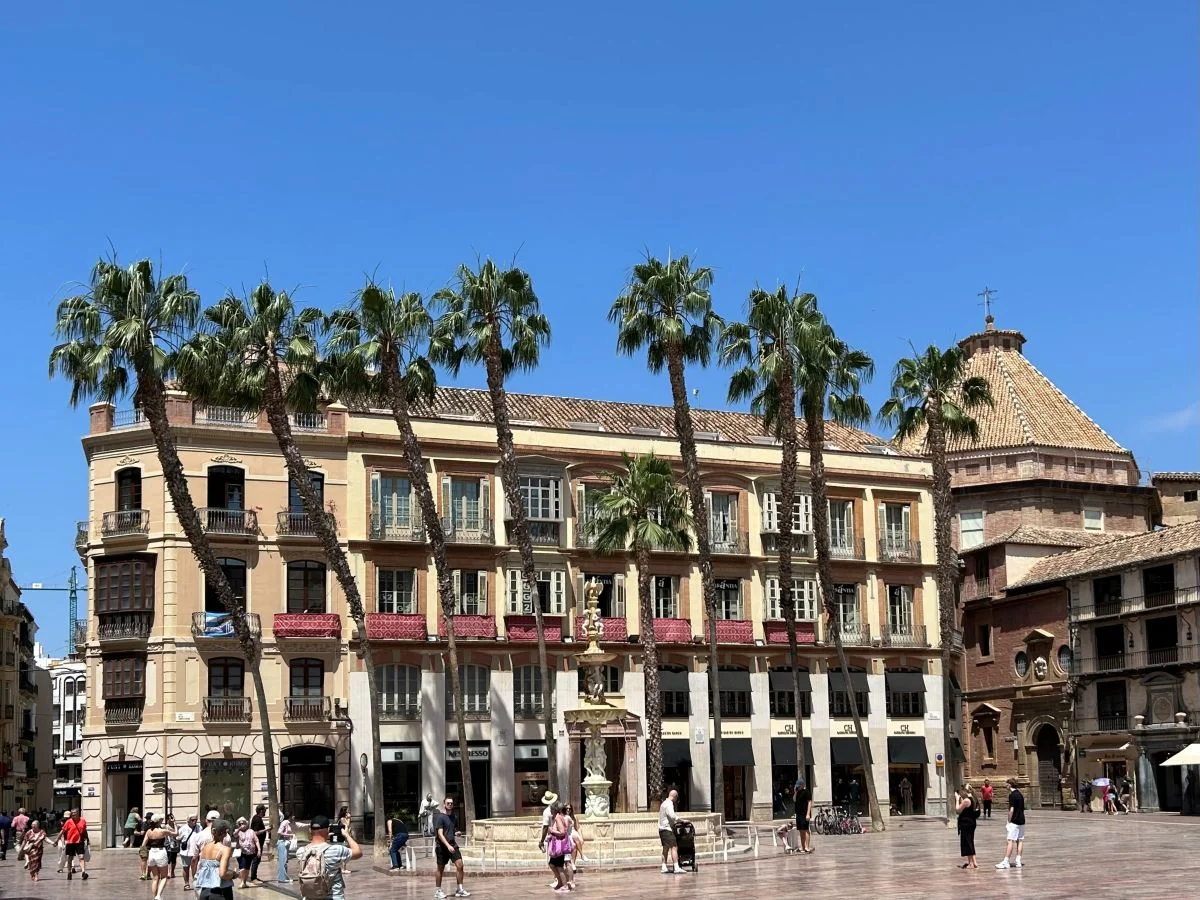Plaza de la Constitución in Málaga historic centre with palm trees and traditional architecture