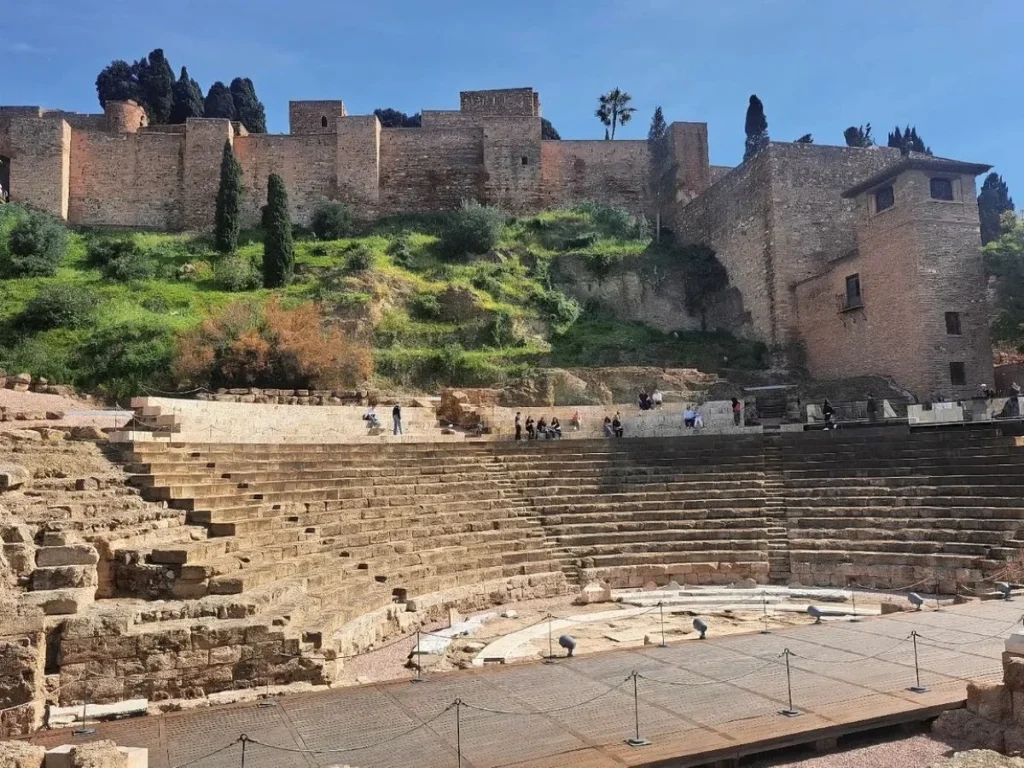 Alcazaba of Málaga with the roman theatre monument and ruins underneath on a sunny day with blue sky