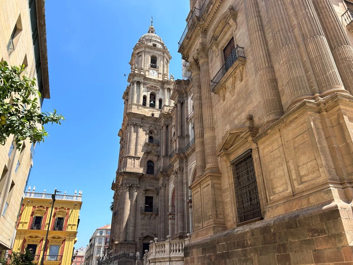 Tower of malaga cathedral la manquita in the old town of the city from the side on a sunny day with blue sky
