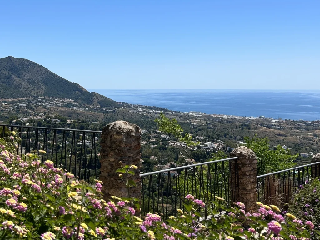 best time to visit malaga with spring flowers overlooking the Málaga coastline and mountains with sea view