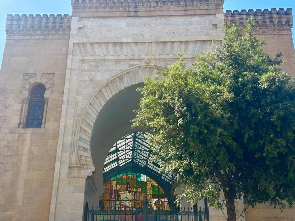 14th century Moorish gateway entrance of Mercado de Atarazanas food market in Málaga with olive tree