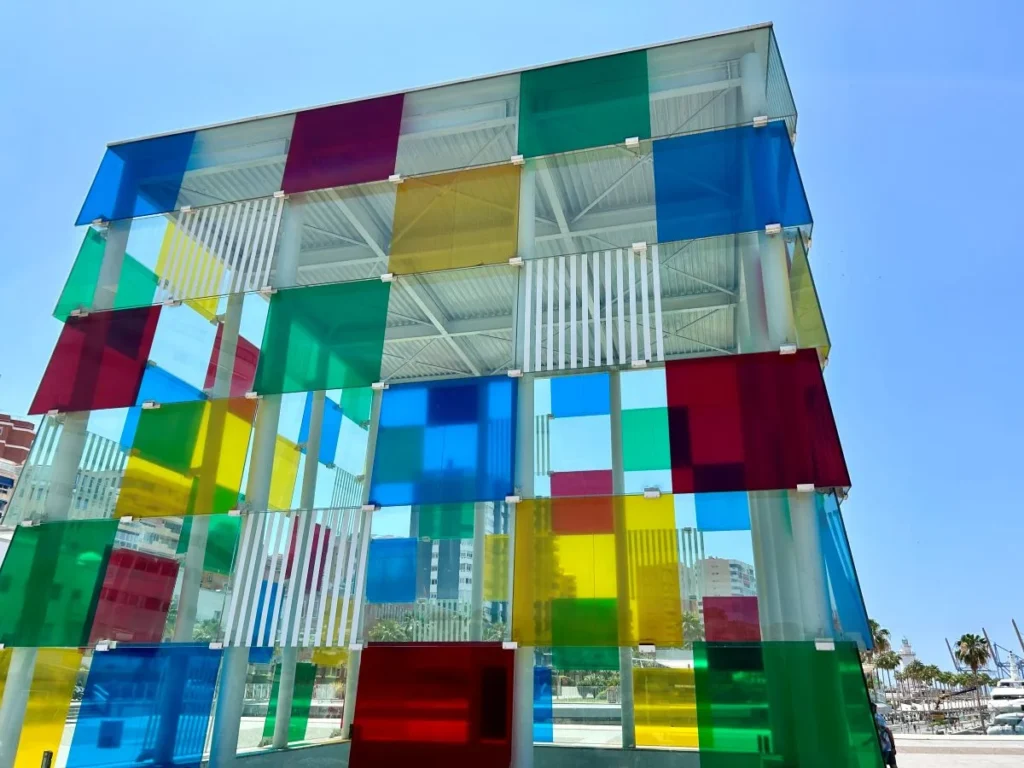 Centre Pompidou Málaga glass cube lit up at dusk on Muelle Uno waterfront harbour
