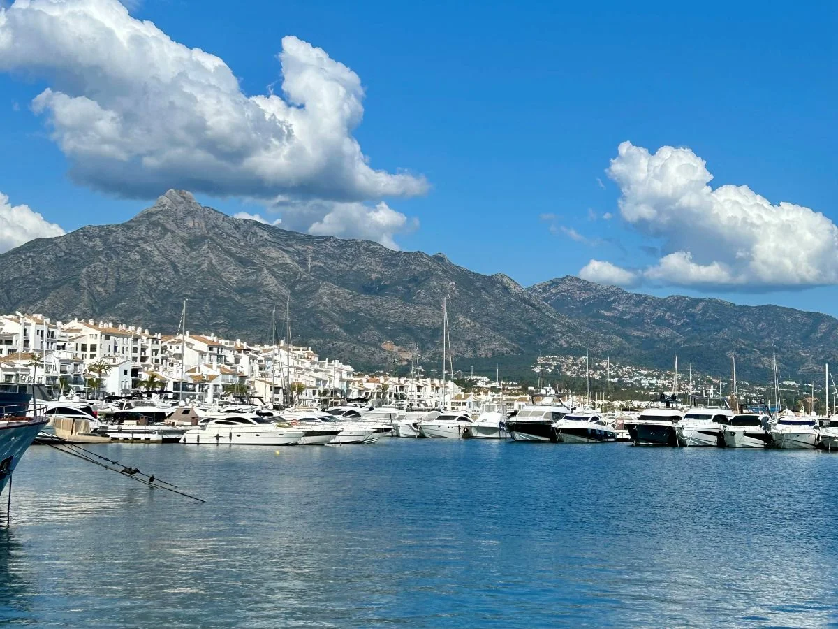Luxury yachts moored at Puerto Banús marina in Marbella with La Concha mountain behind Málaga