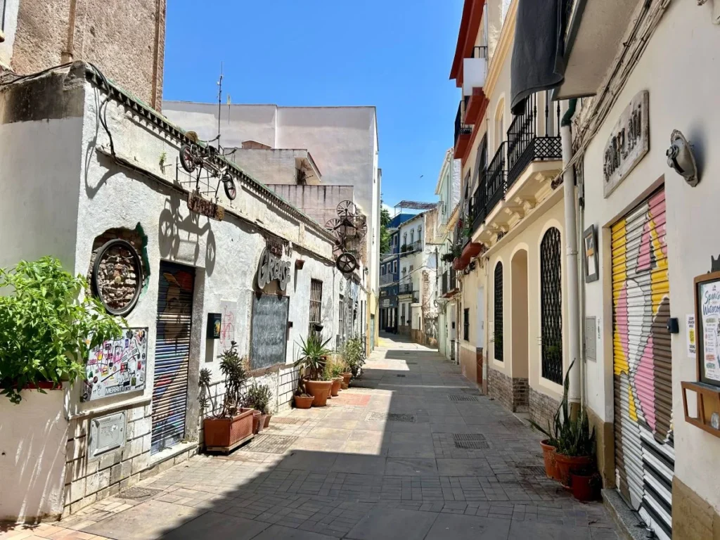 Narrow street with art installations and bars in Soho neighbourhood, Málaga