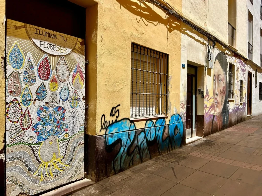 Colourful street art mural on a building facade in Málaga Soho district MAUS project