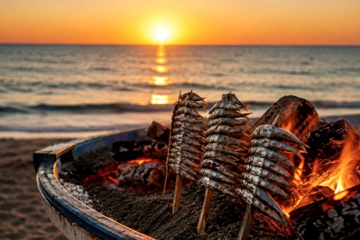 espetos sardines on cane skewers over an open fire grilling on the beach in Málaga during sunset typical spanish food